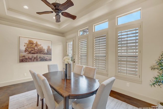 dining area featuring a ceiling fan, crown molding, baseboards, a tray ceiling, and recessed lighting