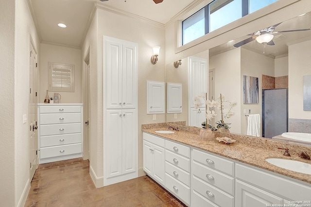 bathroom with crown molding, double vanity, ceiling fan, and a sink