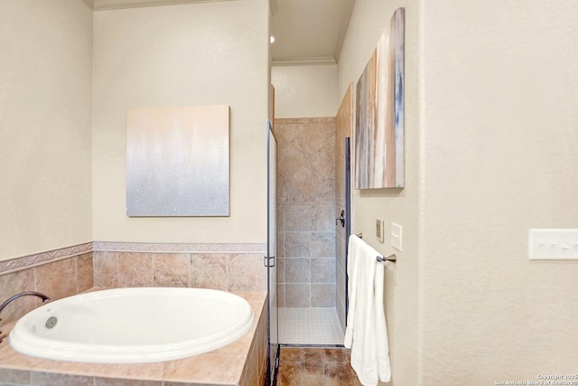 bathroom with a bath and a stall shower