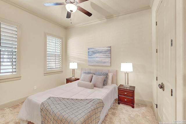 bedroom with multiple windows, baseboards, ornamental molding, and carpet