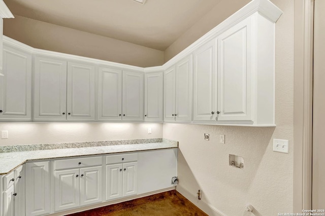 washroom featuring washer hookup, baseboards, hookup for a gas dryer, and cabinet space