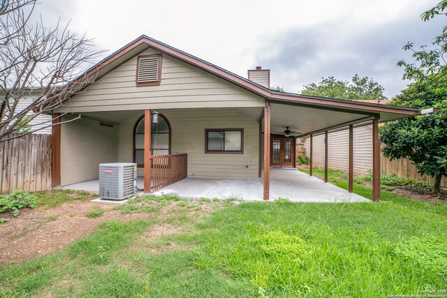 10210 Apricot Fld, San Antonio, TX 78245 - back of property with ceiling fan, fence, a chimney, and central AC