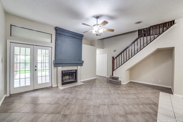 10210 Apricot Fld, San Antonio, TX 78245 - unfurnished living room with french doors, a ceiling fan, a textured ceiling, visible vents, and stairway