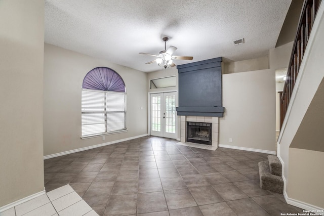10210 Apricot Fld, San Antonio, TX 78245 - unfurnished living room featuring french doors, a ceiling fan, a textured ceiling, and tile patterned floors