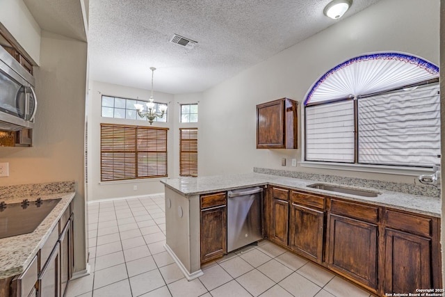 10210 Apricot Fld, San Antonio, TX 78245 - kitchen featuring stainless steel appliances, visible vents, light tile patterned floors, and a peninsula
