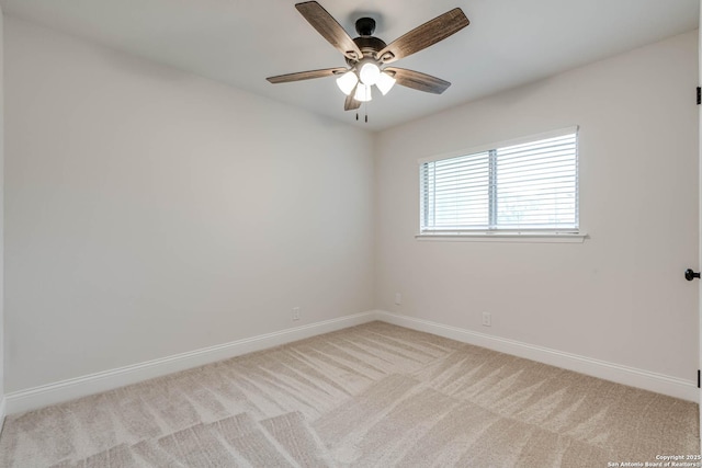 empty room featuring baseboards, ceiling fan, and light carpet
