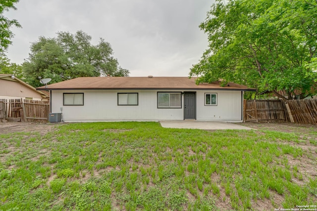 back of house featuring a yard, central AC, a fenced backyard, and a patio area