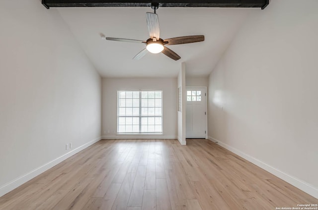 empty room with baseboards, ceiling fan, light wood finished floors, and lofted ceiling