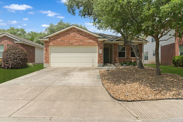ranch-style house featuring a garage, driveway, and brick siding
