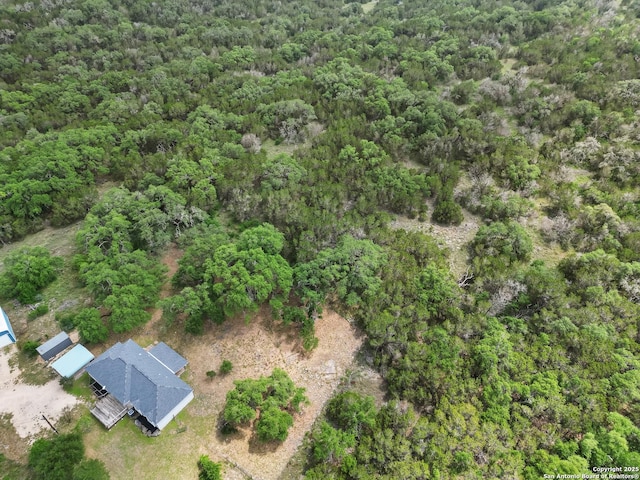 birds eye view of property with a forest view