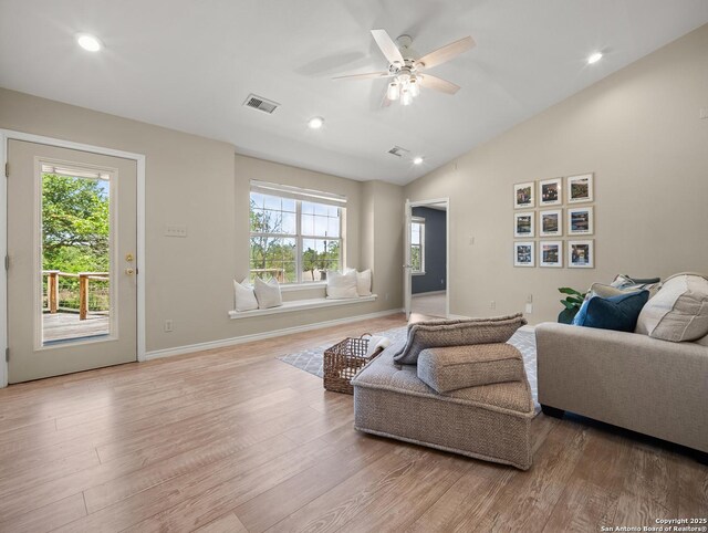 living area with visible vents, a healthy amount of sunlight, and light wood-type flooring