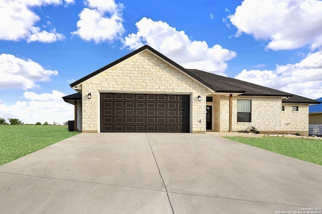 ranch-style home with an attached garage, a front yard, driveway, and stone siding