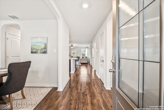 2927 Lindenwood, San Antonio, TX 78245 - hall featuring baseboards, arched walkways, dark wood-style flooring, and visible vents