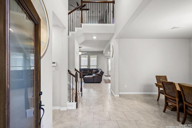 14447 Costa Leon, San Antonio, TX 78245 - tiled entryway featuring stairs, a ceiling fan, baseboards, and a high ceiling