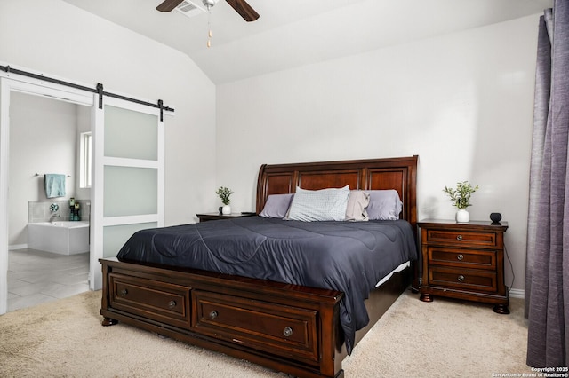 14447 Costa Leon, San Antonio, TX 78245 - bedroom featuring a barn door, vaulted ceiling, connected bathroom, carpet flooring, and a ceiling fan