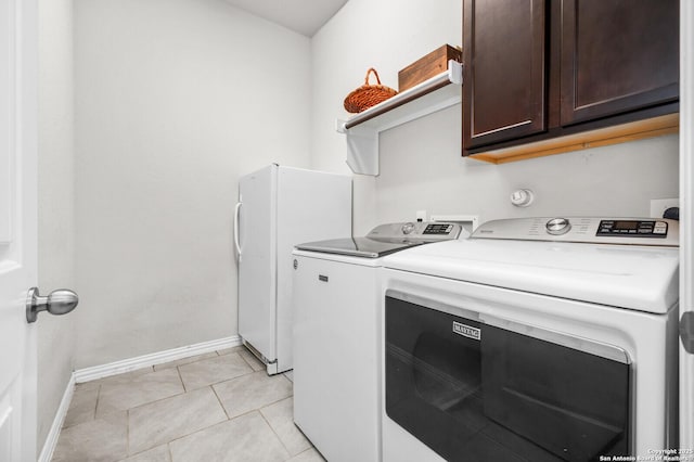 14447 Costa Leon, San Antonio, TX 78245 - washroom with separate washer and dryer, baseboards, cabinet space, and light tile patterned floors