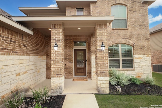 14447 Costa Leon, San Antonio, TX 78245 - view of exterior entry featuring brick siding, stone siding, and central AC