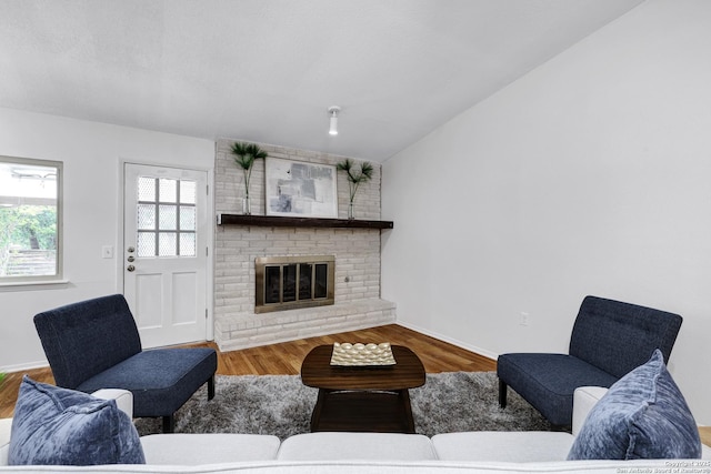 14320 Forum Rd, Universal City, TX 78148 - living area with a fireplace, wood finished floors, and lofted ceiling