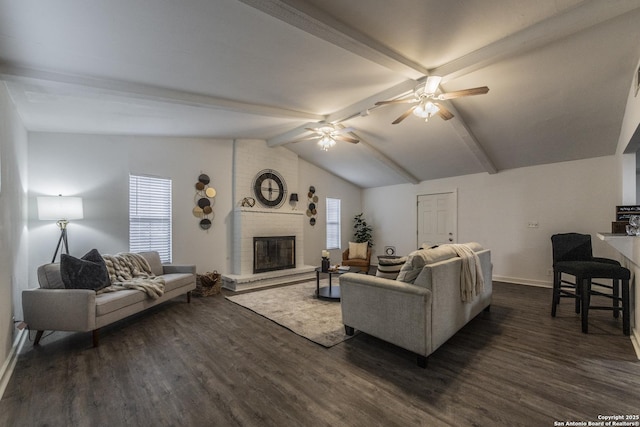 living area featuring ceiling fan, a fireplace, baseboards, vaulted ceiling with beams, and dark wood-style floors