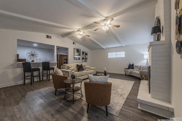living room with lofted ceiling with beams, a brick fireplace, baseboards, visible vents, and dark wood-style floors