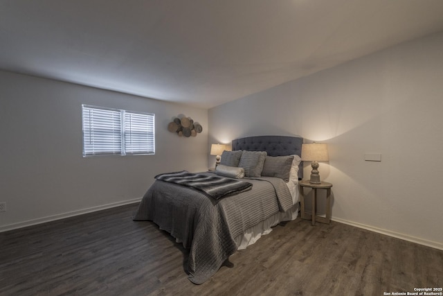 bedroom with baseboards and wood finished floors