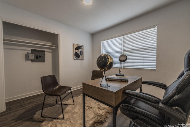 office space with baseboards, wood finished floors, and electric panel