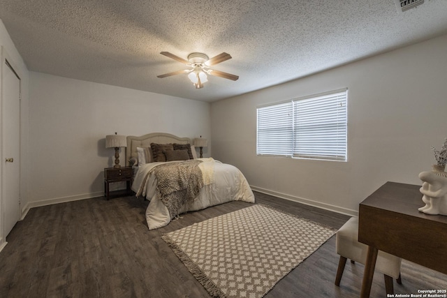 bedroom featuring baseboards, a ceiling fan, a textured ceiling, and wood finished floors