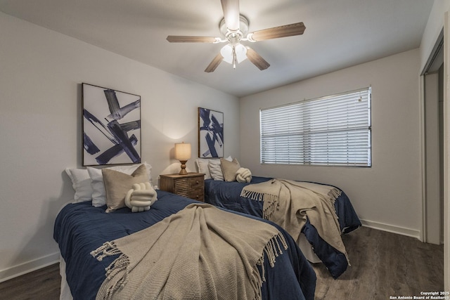 bedroom with baseboards, dark wood finished floors, and ceiling fan