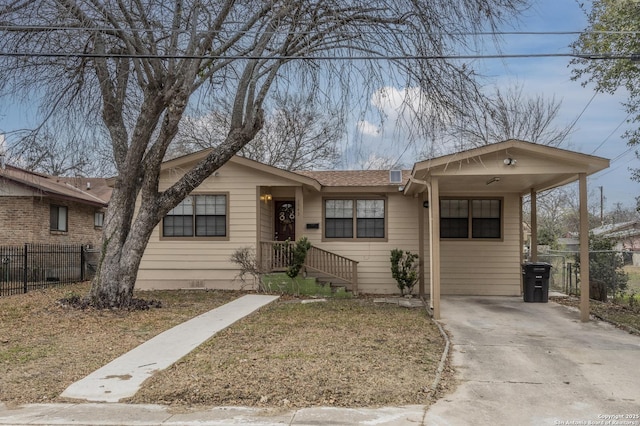 ranch-style house with fence, driveway, and a carport