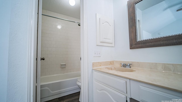 bathroom with vanity, shower / bathing tub combination, toilet, and wood finished floors