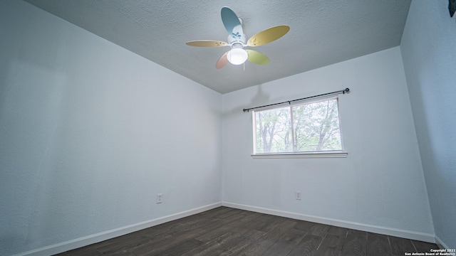 unfurnished room with baseboards, a textured ceiling, ceiling fan, and dark wood-style floors