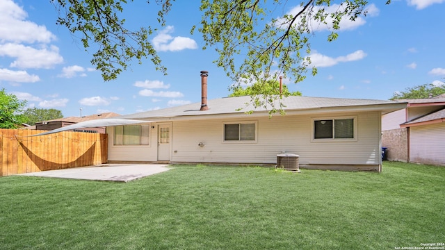 rear view of house featuring a yard, fence, a patio area, and cooling unit