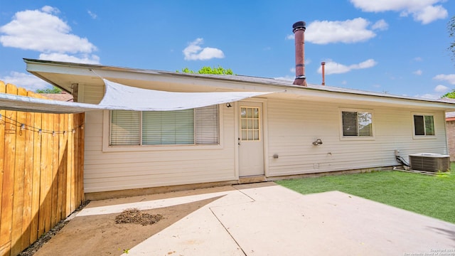 view of front of home with a front lawn, a patio area, and cooling unit