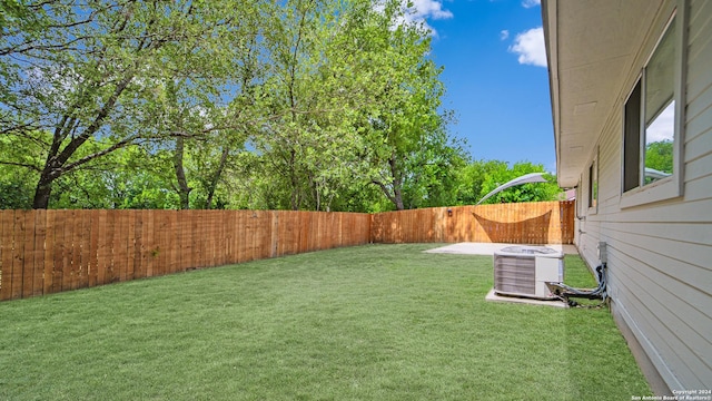 view of yard featuring central AC unit and a fenced backyard