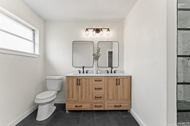 bathroom with baseboards, a sink, a marble finish shower, and toilet
