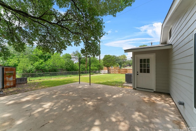 view of patio with a fenced backyard and central AC unit