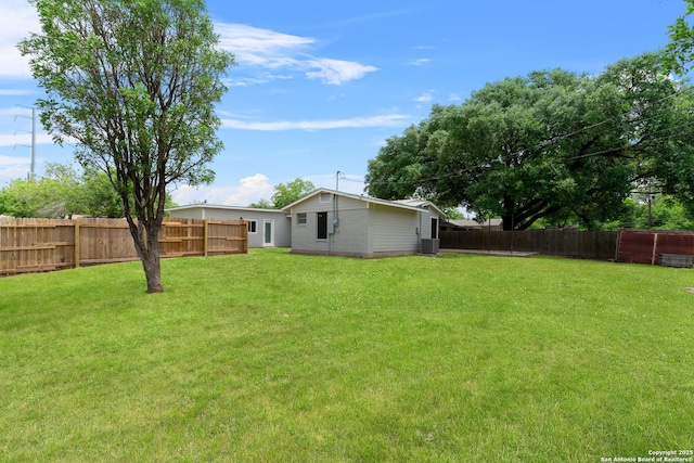 view of yard featuring a fenced backyard and central AC unit