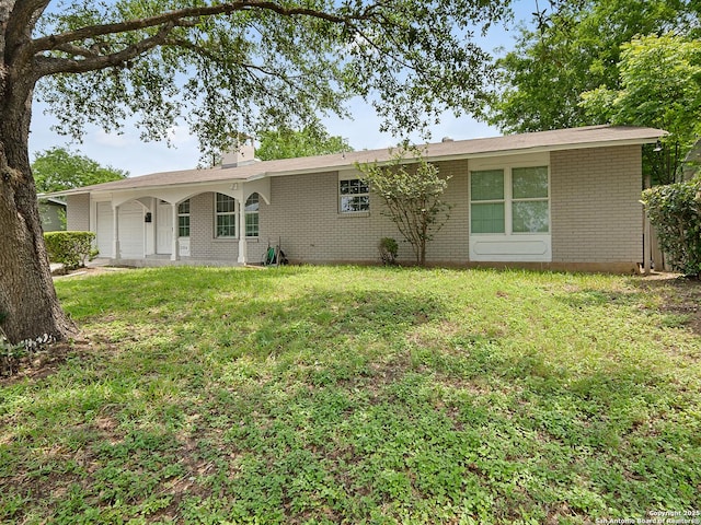 3354 Bob Billa, San Antonio, TX 78223 - back of house featuring a lawn, a chimney, and brick siding