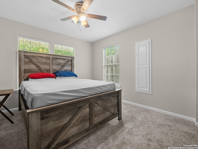 carpeted bedroom featuring baseboards and ceiling fan