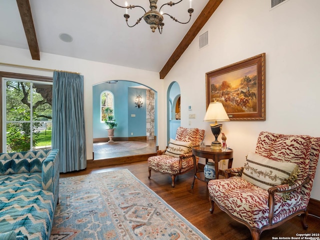 220 N School St, Boerne, TX 78006 - living area with visible vents, arched walkways, wood finished floors, lofted ceiling with beams, and a notable chandelier