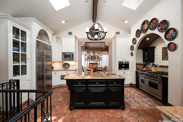 220 N School St, Boerne, TX 78006 - kitchen with dark cabinetry, white cabinetry, and built in appliances