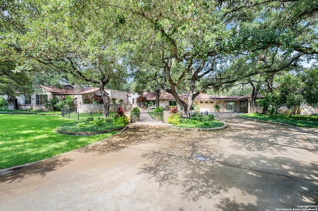 220 N School St, Boerne, TX 78006 - view of front facade with curved driveway, fence private yard, and a front yard