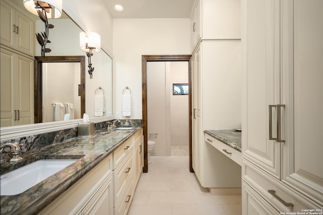 220 N School St, Boerne, TX 78006 - bathroom featuring double vanity, toilet, tile patterned floors, and a sink
