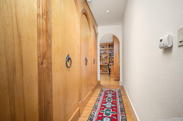 220 N School St, Boerne, TX 78006 - corridor featuring arched walkways, baseboards, and light wood-type flooring