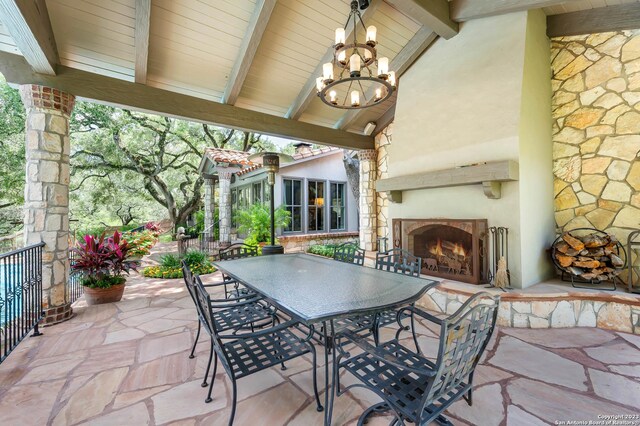 220 N School St, Boerne, TX 78006 - view of patio featuring outdoor dining area and a lit fireplace