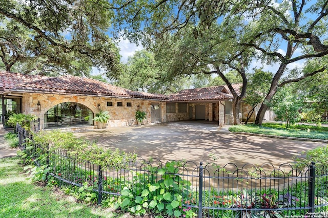 220 N School St, Boerne, TX 78006 - view of front of home featuring fence, a tiled roof, and stone siding