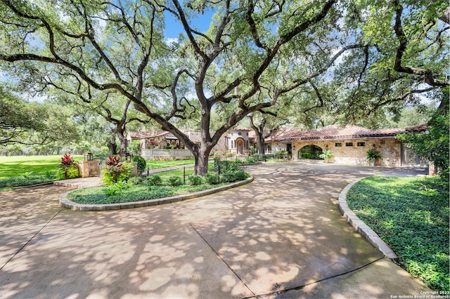 220 N School St, Boerne, TX 78006 - view of front facade featuring a tiled roof and stone siding