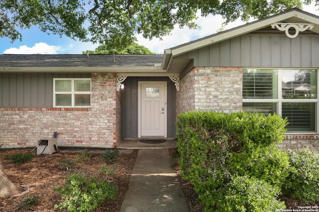 property entrance featuring brick siding