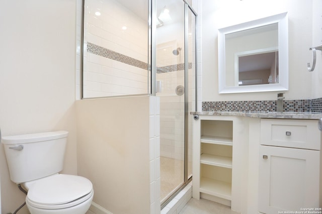 bathroom with vanity, toilet, and a shower stall