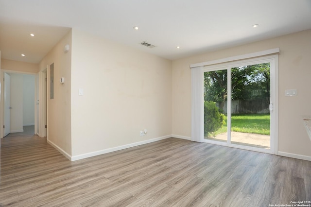 unfurnished room featuring recessed lighting, baseboards, light wood finished floors, and visible vents